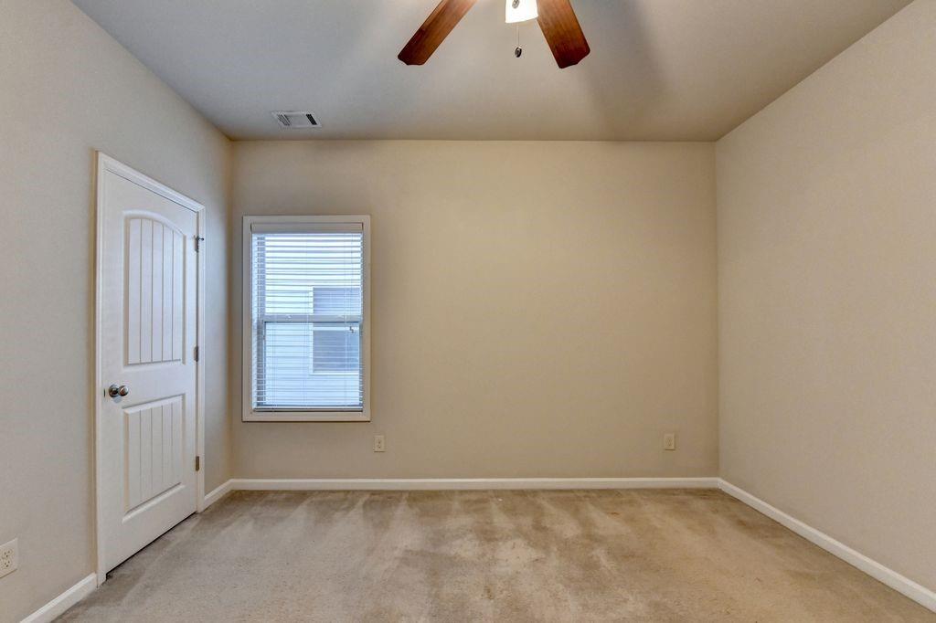 5166 Apple Grove Road Northeast Buford, GA 30519 - Photo 21 of 29 an empty room with windows and cabinet