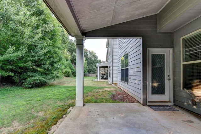 a view of a porch with a floor to ceiling window and an outdoor view