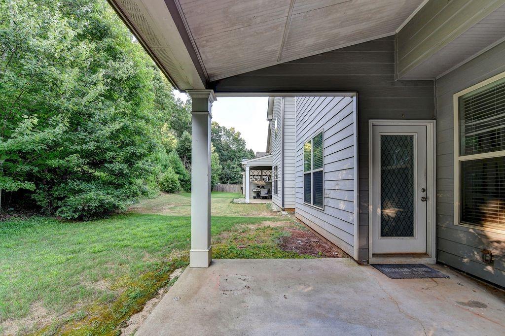 5166 Apple Grove Road Northeast Buford, GA 30519 - Photo 27 of 29 a view of a porch with a floor to ceiling window and an outdoor view