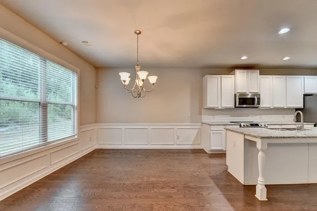 a view of a kitchen with a sink cabinets and stainless steel appliances