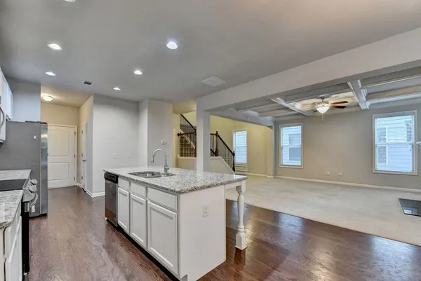 a kitchen with stainless steel appliances granite countertop a stove a refrigerator and a sink