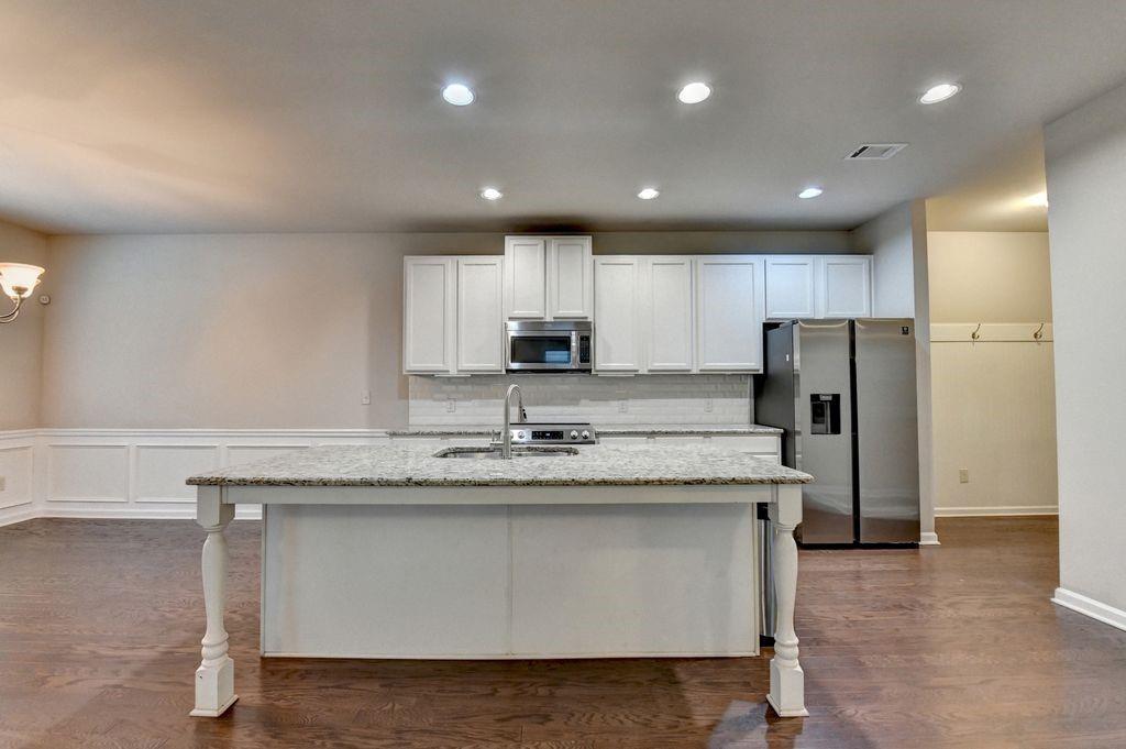 5166 Apple Grove Road Northeast Buford, GA 30519 - Photo 10 of 29 a kitchen with stainless steel appliances granite countertop a sink and a refrigerator