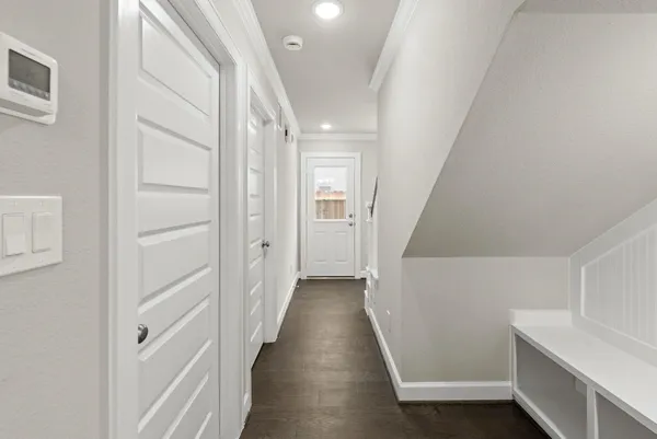 a view of a hallway with wooden floor and staircase