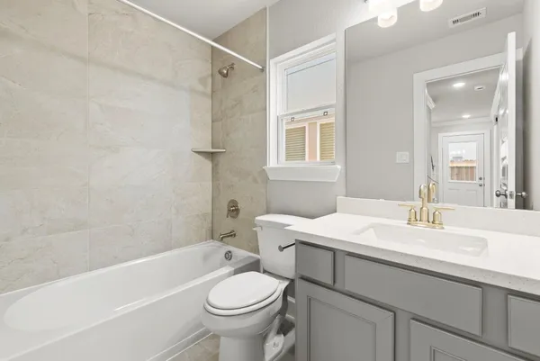 a bathroom with a sink toilet vanity and shower