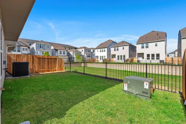 a view of a garden with a house in the background