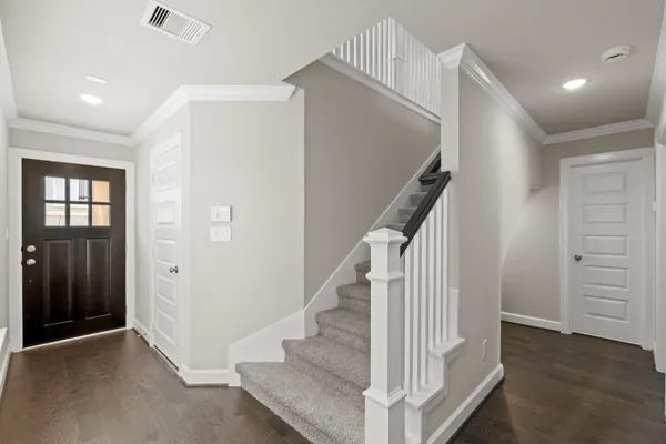 a view of entryway with wooden floor and stairs