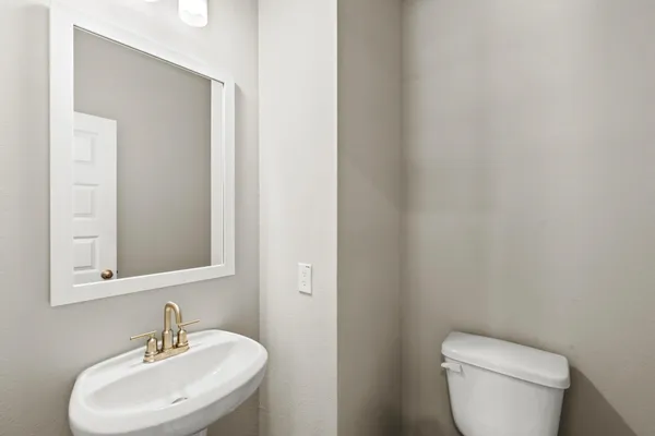 a white toilet sitting next to a bathroom sink