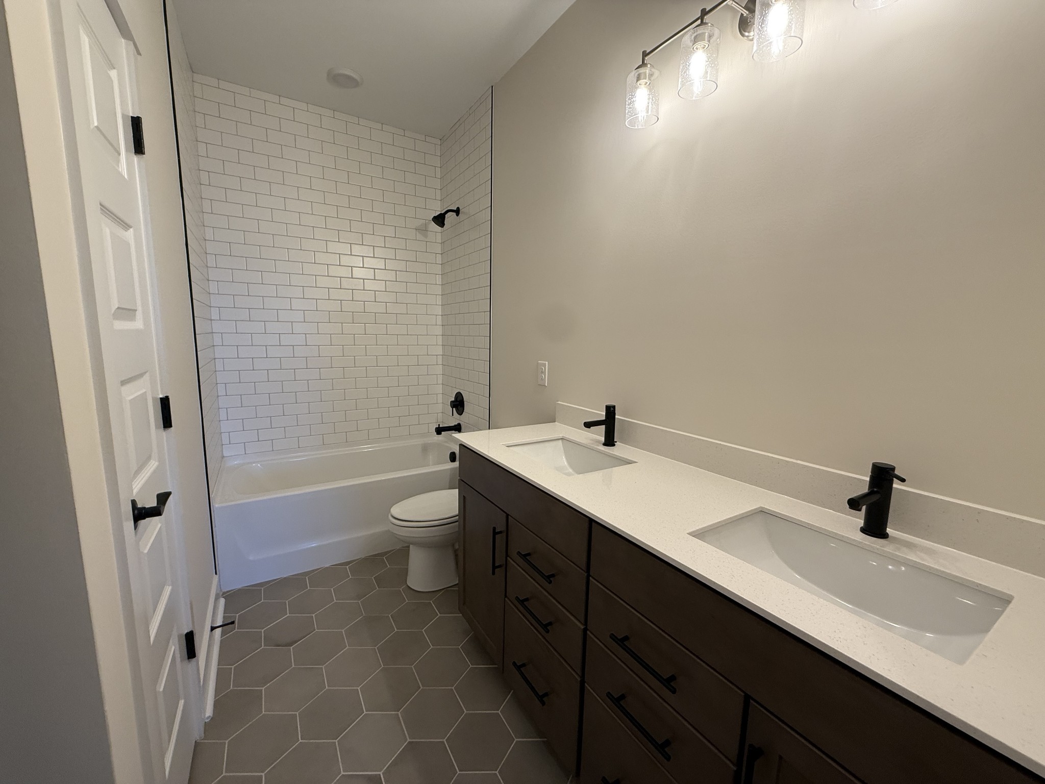 7744 Second Fiddle Way Arrington, TN 37014 - Photo 28 of 31 a bathroom with a double vanity sink toilet and shower