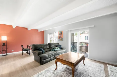 a living room with furniture a lamp and a window