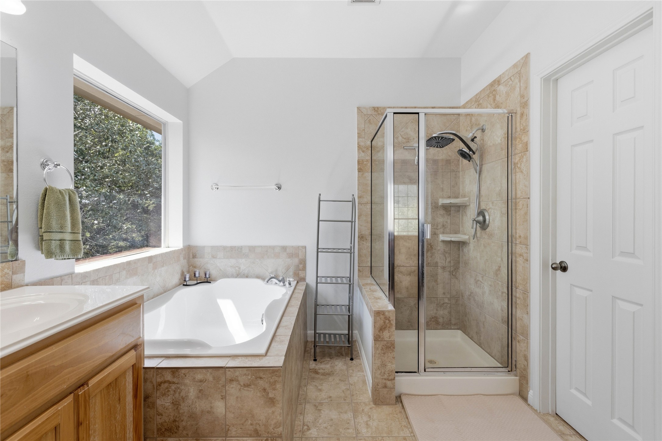 8122 Lime Creek Road Volente, TX 78641 - Photo 24 of 40 Primary bath with garden tub and more hill country views and natural light