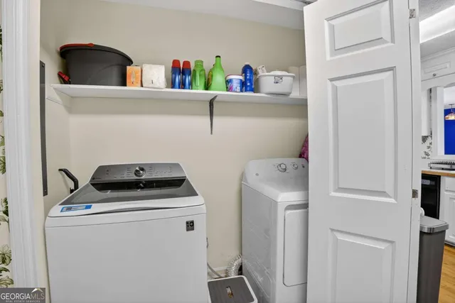 a kitchen with stainless steel appliances white cabinets white stove a refrigerator and a microwave