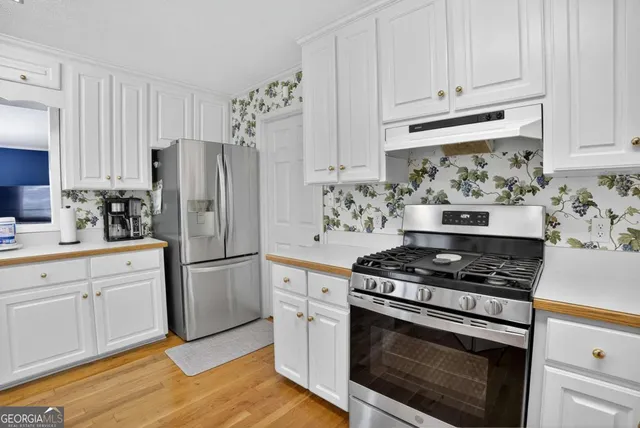 a kitchen with sink and cabinets