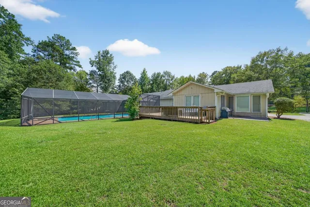 a front view of a house with a garden and deck