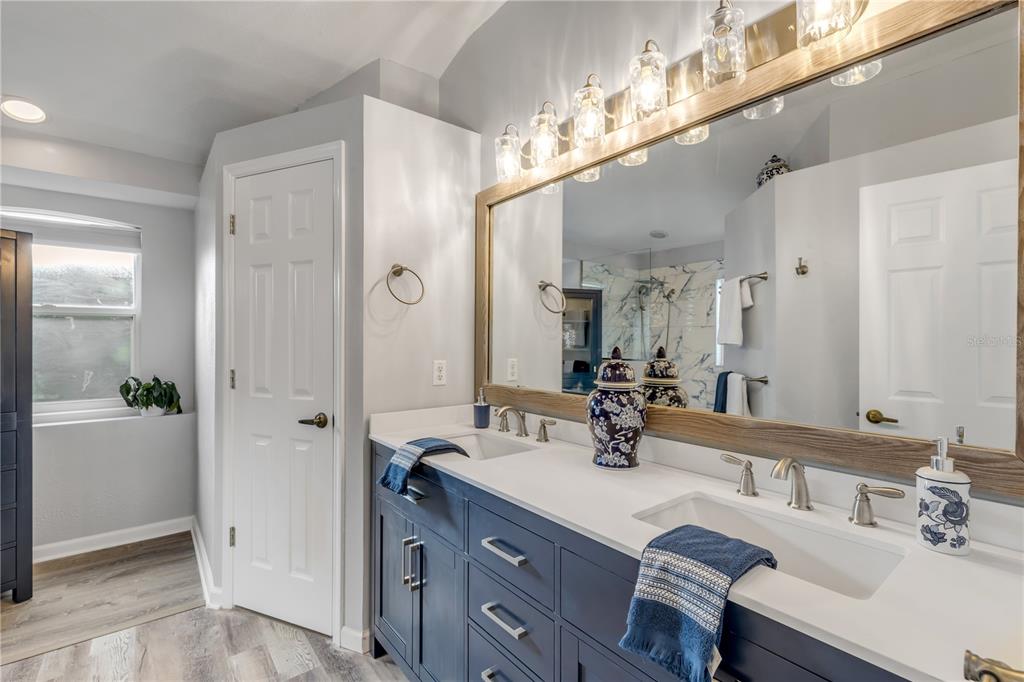 12232 Bronson Way Orlando, FL 32824 - Photo 13 of 32 a bathroom with a sink double vanity granite tub and shower
