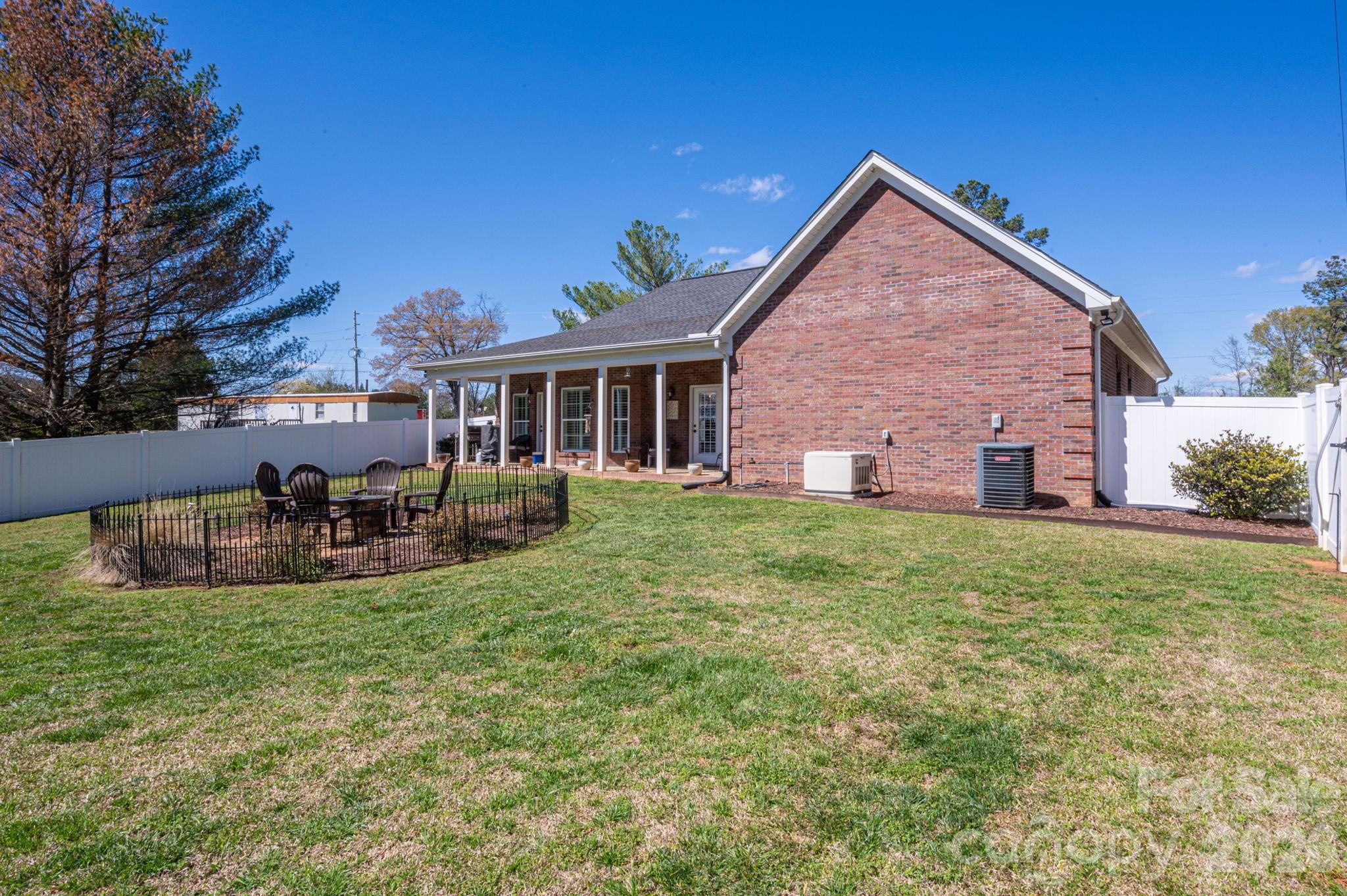 140 Huffstetler Lake Road Dallas, NC 28034 - Photo 18 of 22 a view of a house with a yard porch and sitting area