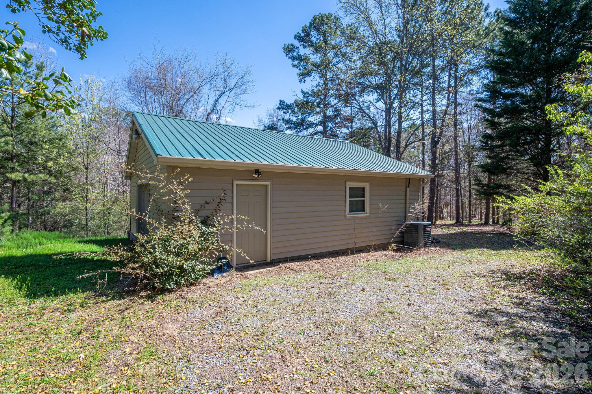 140 Huffstetler Lake Road Dallas, NC 28034 - Photo 21 of 22 a front view of a house with a yard and garage