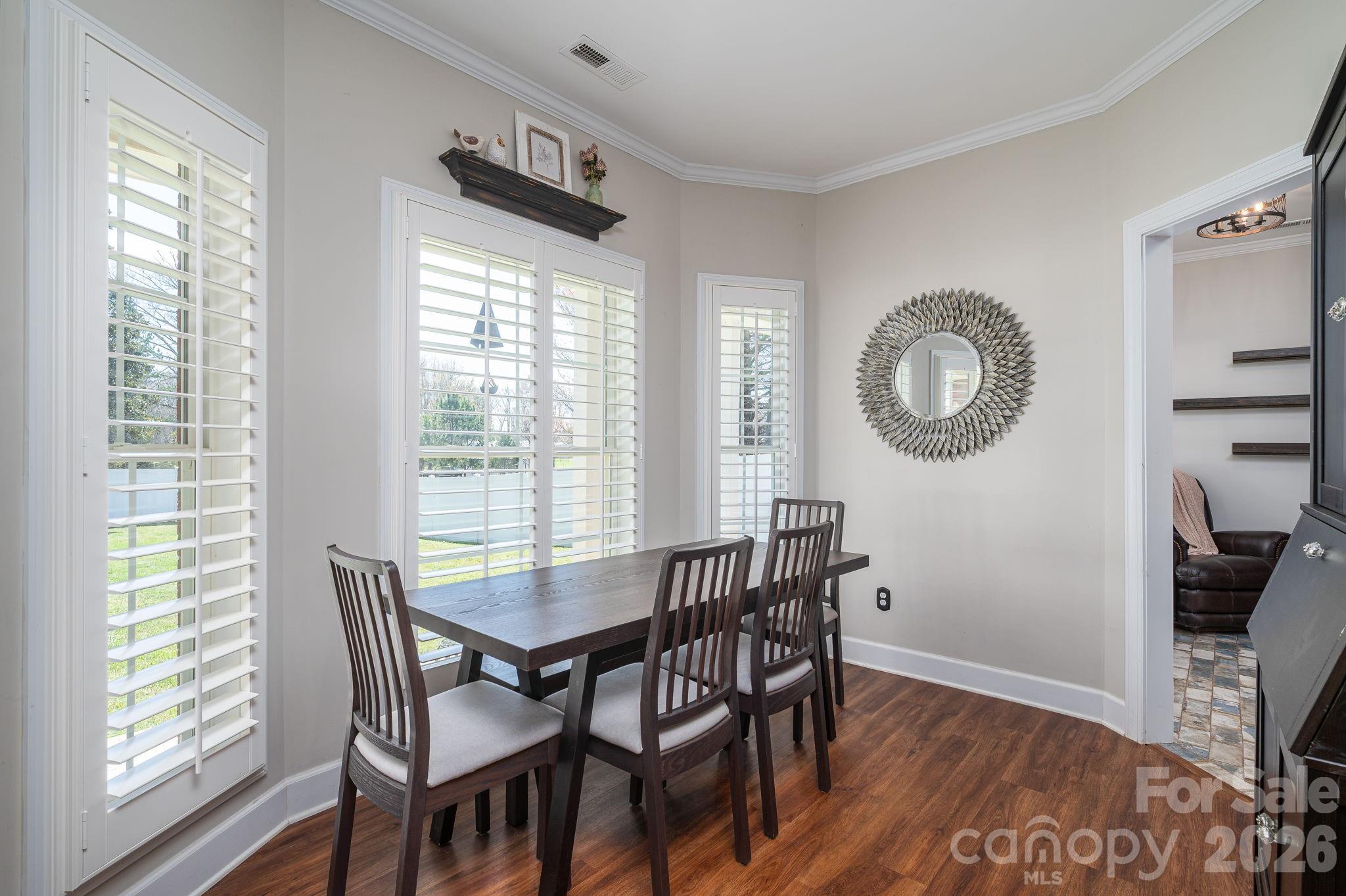 140 Huffstetler Lake Road Dallas, NC 28034 - Photo 7 of 22 a view of a dining room with furniture a rug and wooden floor