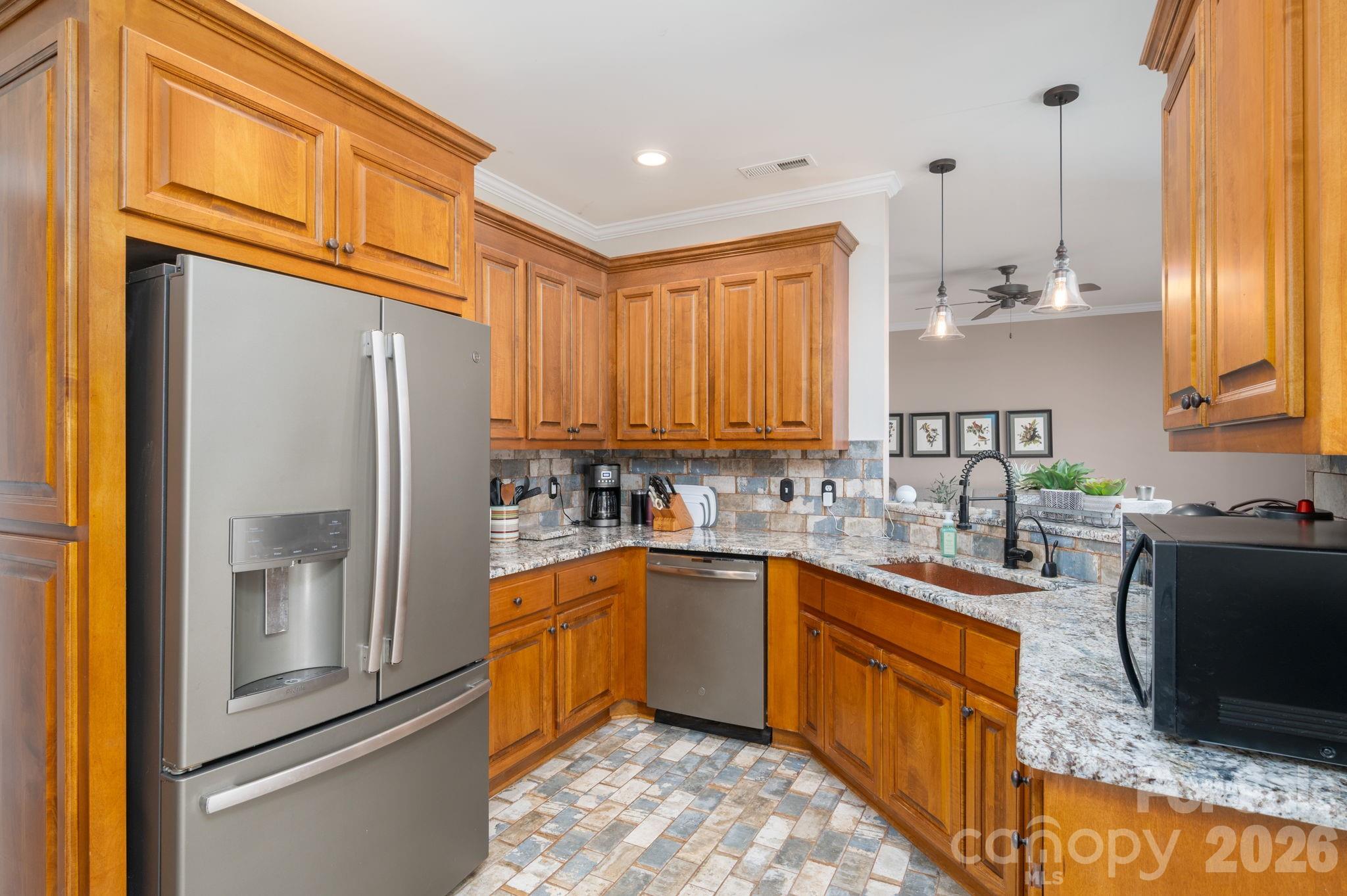 140 Huffstetler Lake Road Dallas, NC 28034 - Photo 10 of 22 a kitchen with stainless steel appliances granite countertop a sink stove refrigerator and cabinets