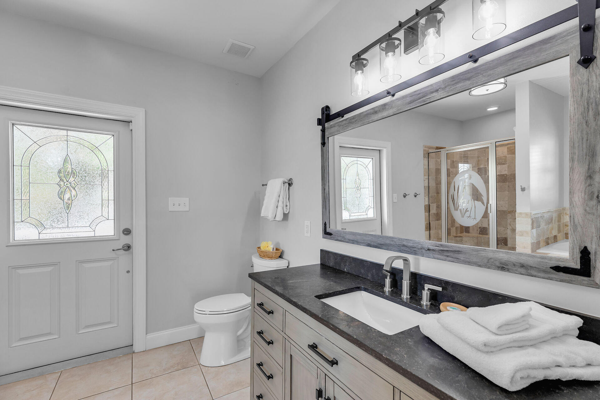 412 122nd Street Marathon, FL 33050 - Photo 14 of 43 a bathroom with a granite countertop sink a toilet and a mirror