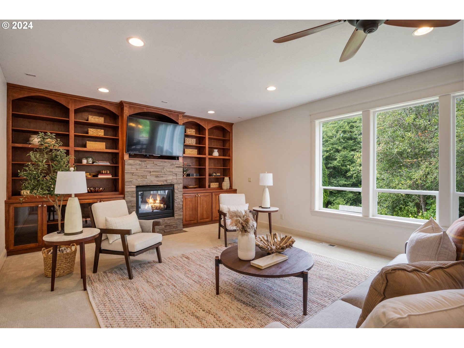 2204 South 17th Way Ridgefield, WA 98642 - Photo 14 of 45 a living room with furniture a fireplace and a large window