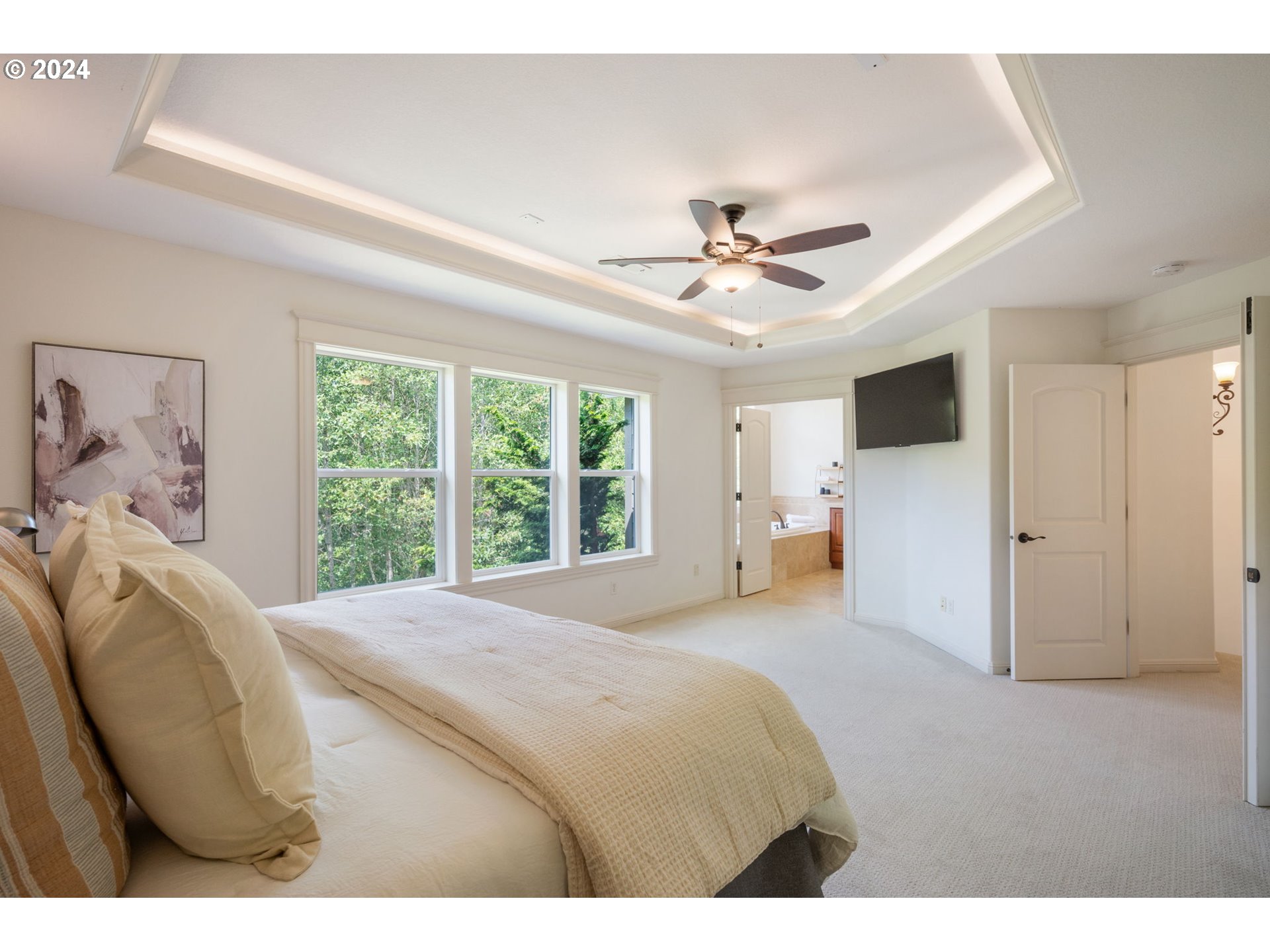 2204 South 17th Way Ridgefield, WA 98642 - Photo 20 of 45 a spacious bedroom with a bed and a chandelier