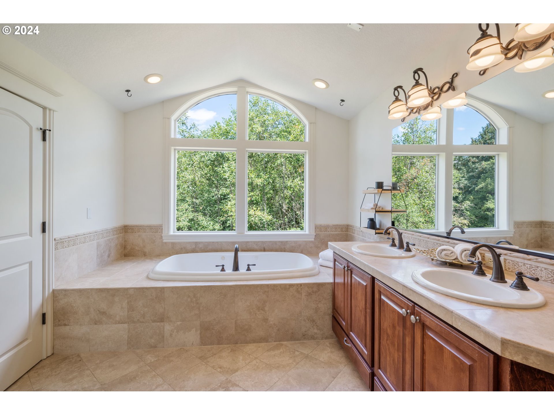 2204 South 17th Way Ridgefield, WA 98642 - Photo 23 of 45 a bathroom with a tub sink and window