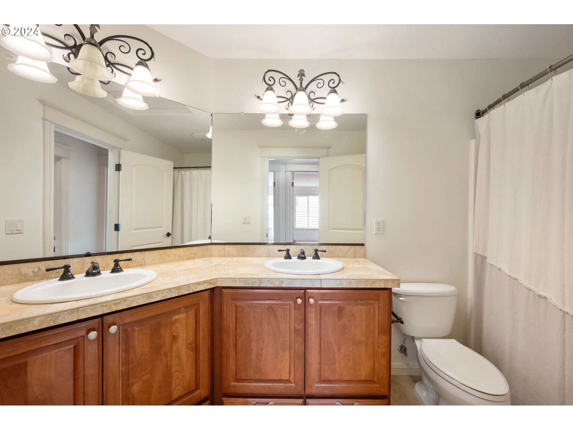2204 South 17th Way Ridgefield, WA 98642 - Photo 25 of 45 a bathroom with a sink a toilet and a mirror