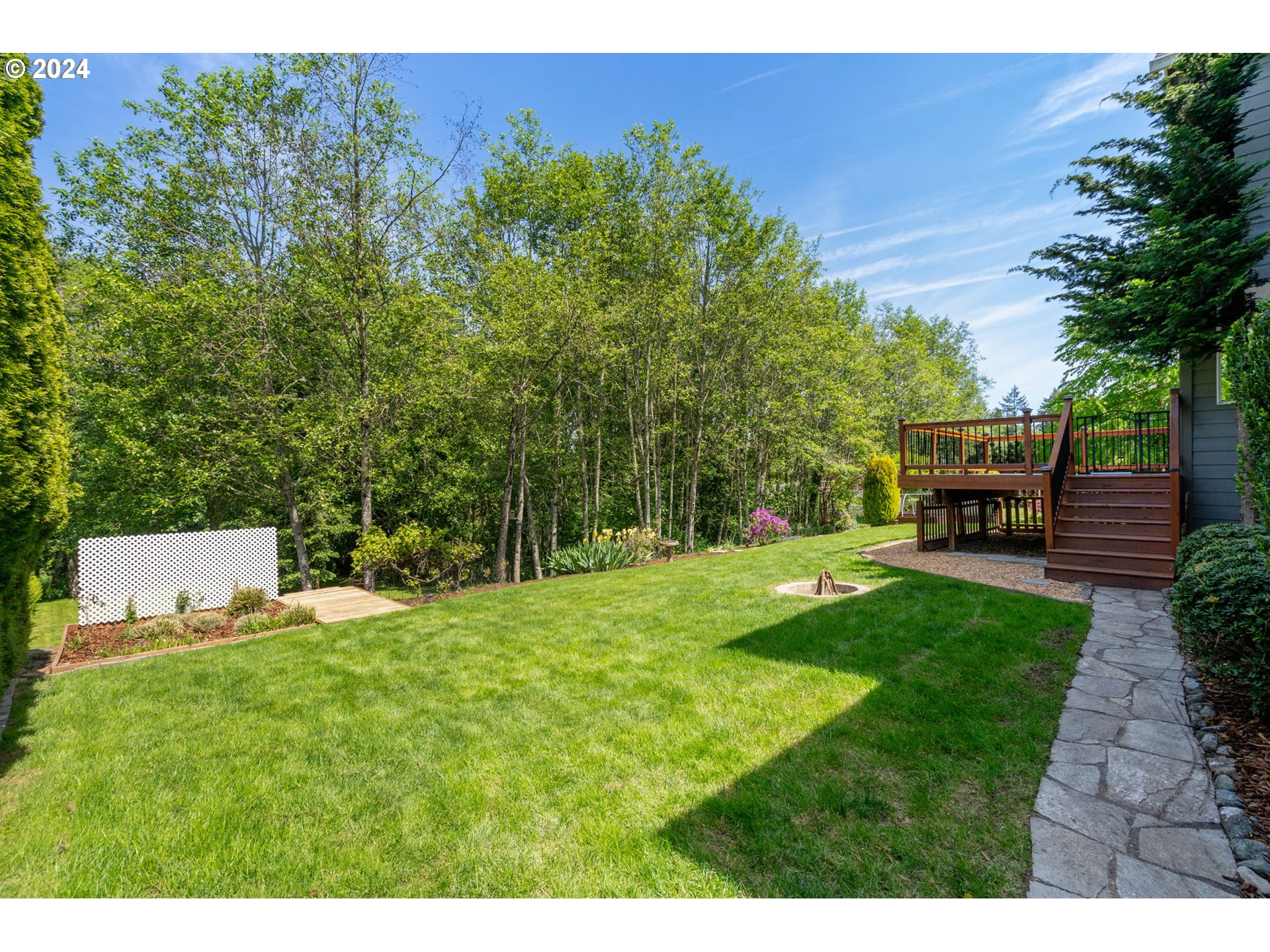 2204 South 17th Way Ridgefield, WA 98642 - Photo 33 of 45 a backyard of a house with a garden and plants