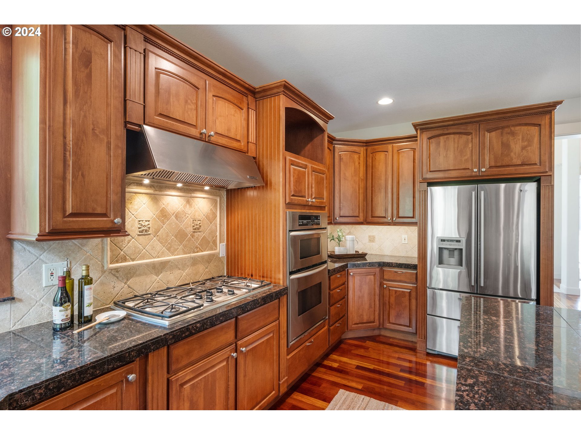2204 South 17th Way Ridgefield, WA 98642 - Photo 6 of 45 a kitchen with stainless steel appliances granite countertop a stove a refrigerator and a sink