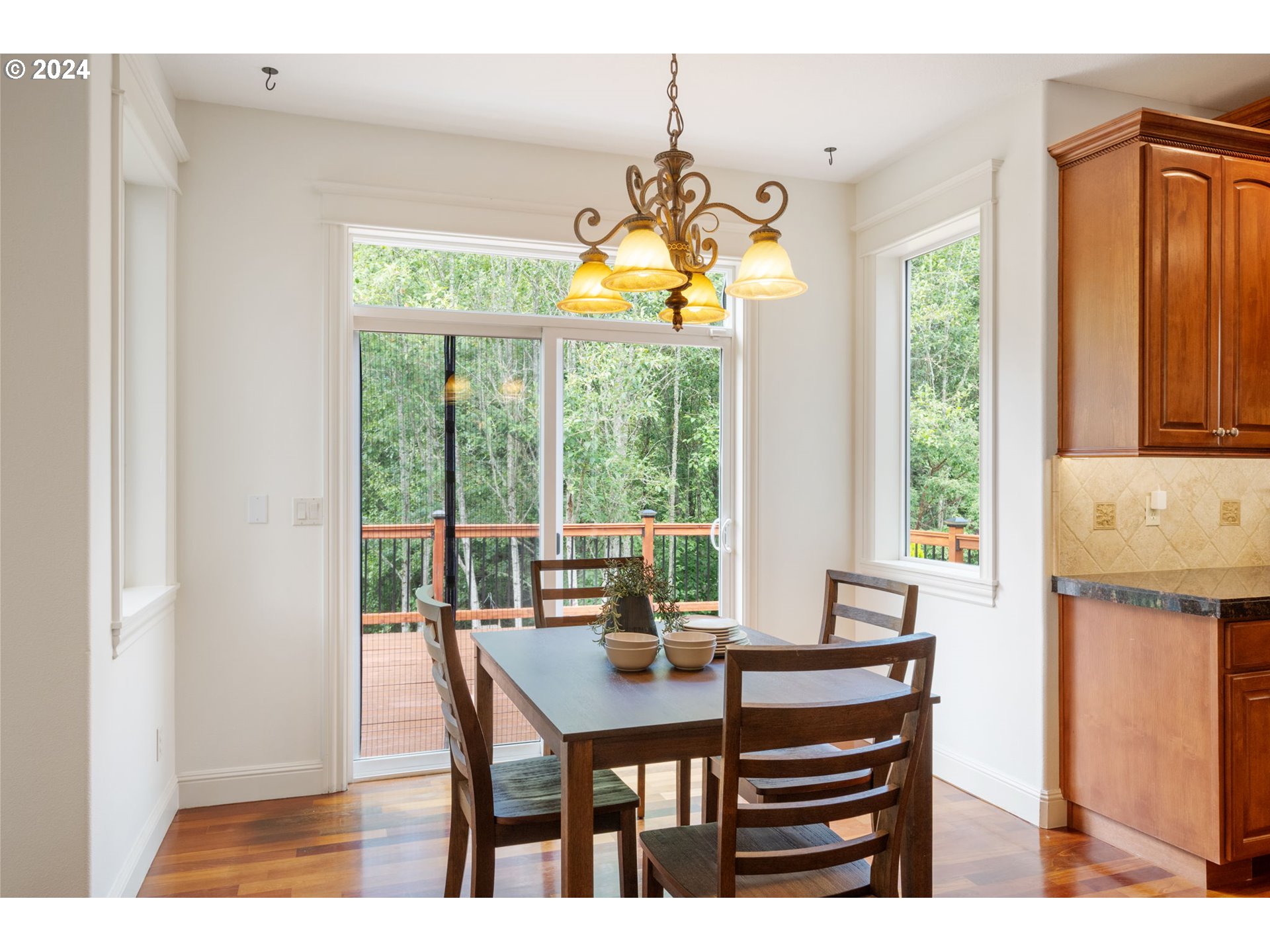 2204 South 17th Way Ridgefield, WA 98642 - Photo 9 of 45 a view of a dining room with furniture large windows and wooden floor