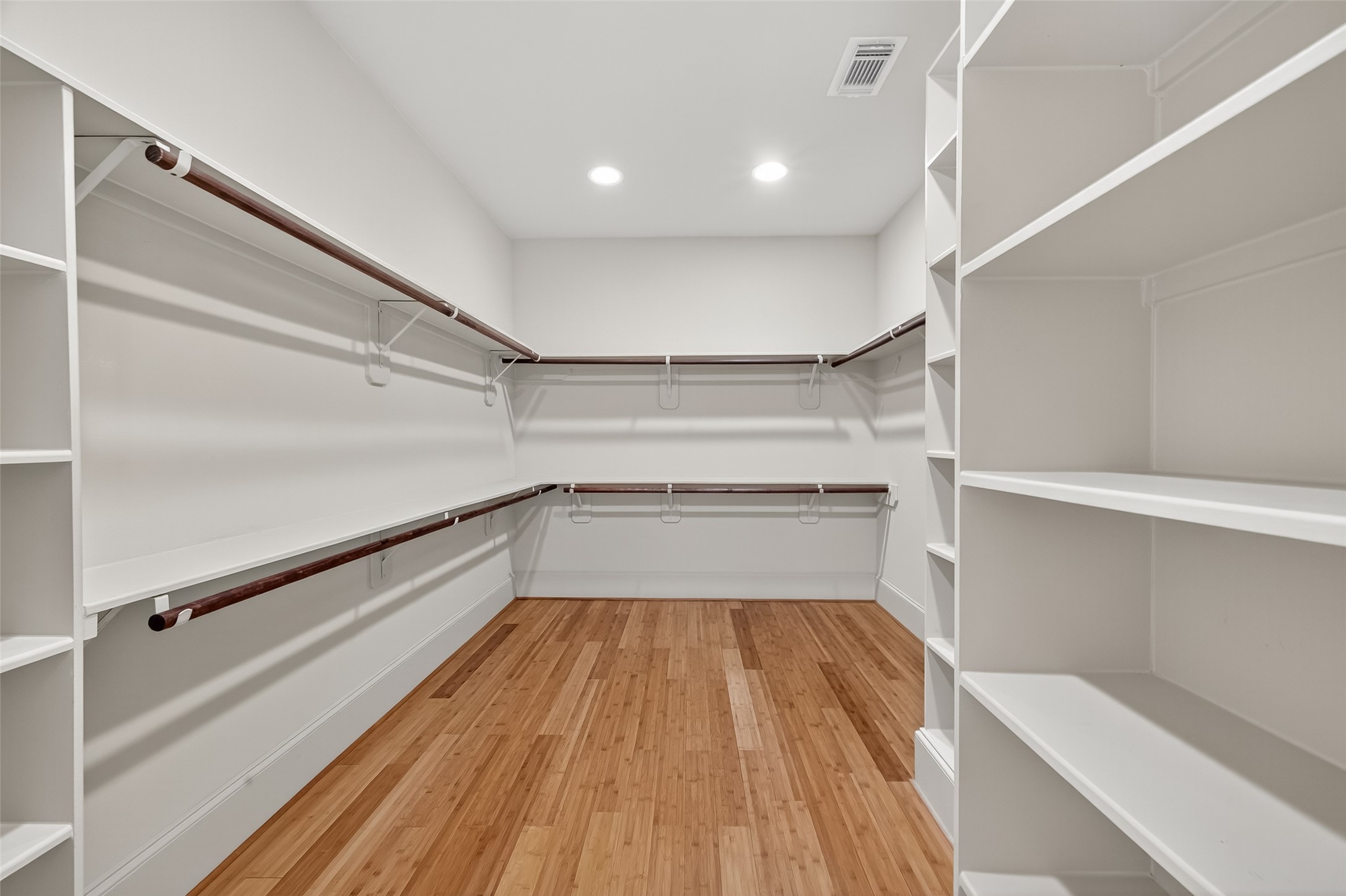 931 West 23rd Street, Unit K Houston, TX 77008 - Photo 20 of 40 12'6" x 8'10" walk-in closet has the bamboo hardwood flooring, built-in shelving and hanging racks.