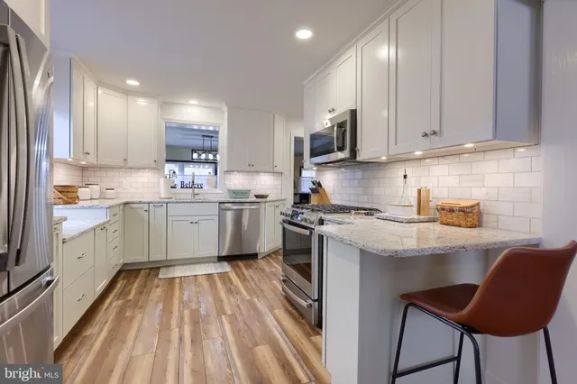 a kitchen with a sink window and cabinets