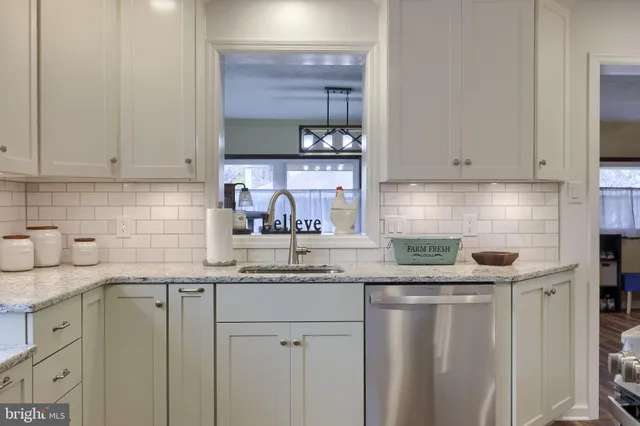 a kitchen with stainless steel appliances granite countertop a sink and cabinets