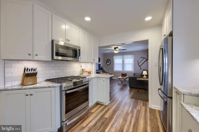 a kitchen with a stove a sink and a refrigerator