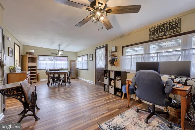 a dining room with furniture and wooden floor