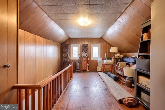 a view of a hallway with workspace and a window