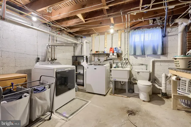 a utility room with a stove top oven a washer and dryer
