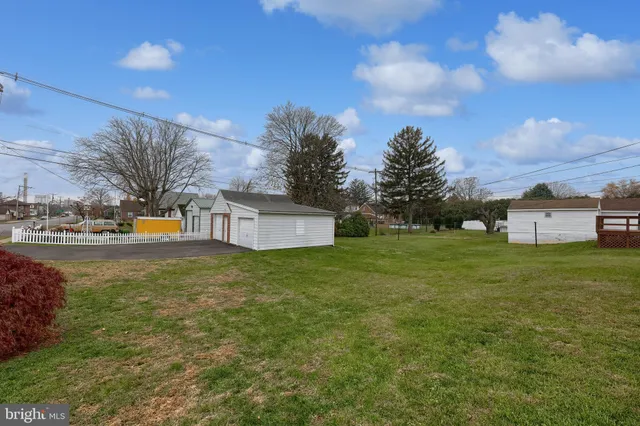 a tall yellow building with trees in the background