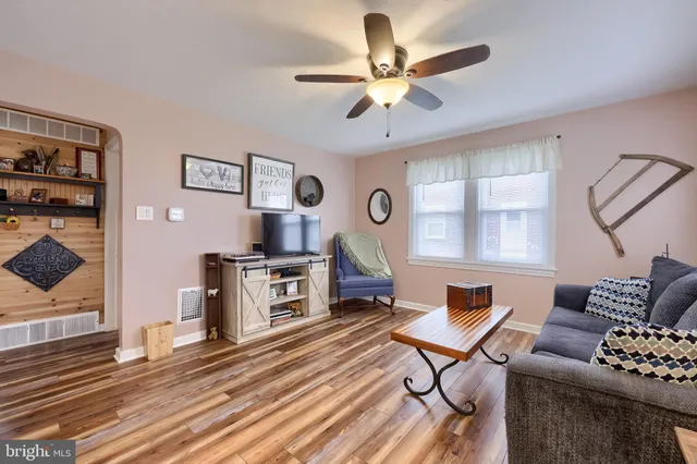 a living room with furniture a dining table and a fireplace