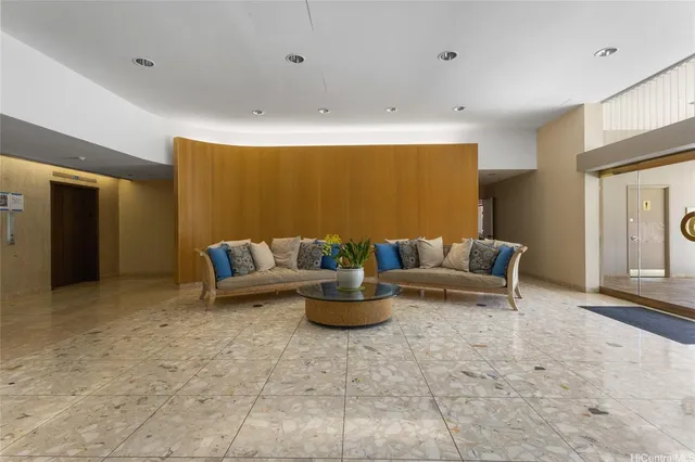 a living room with furniture and a potted plant