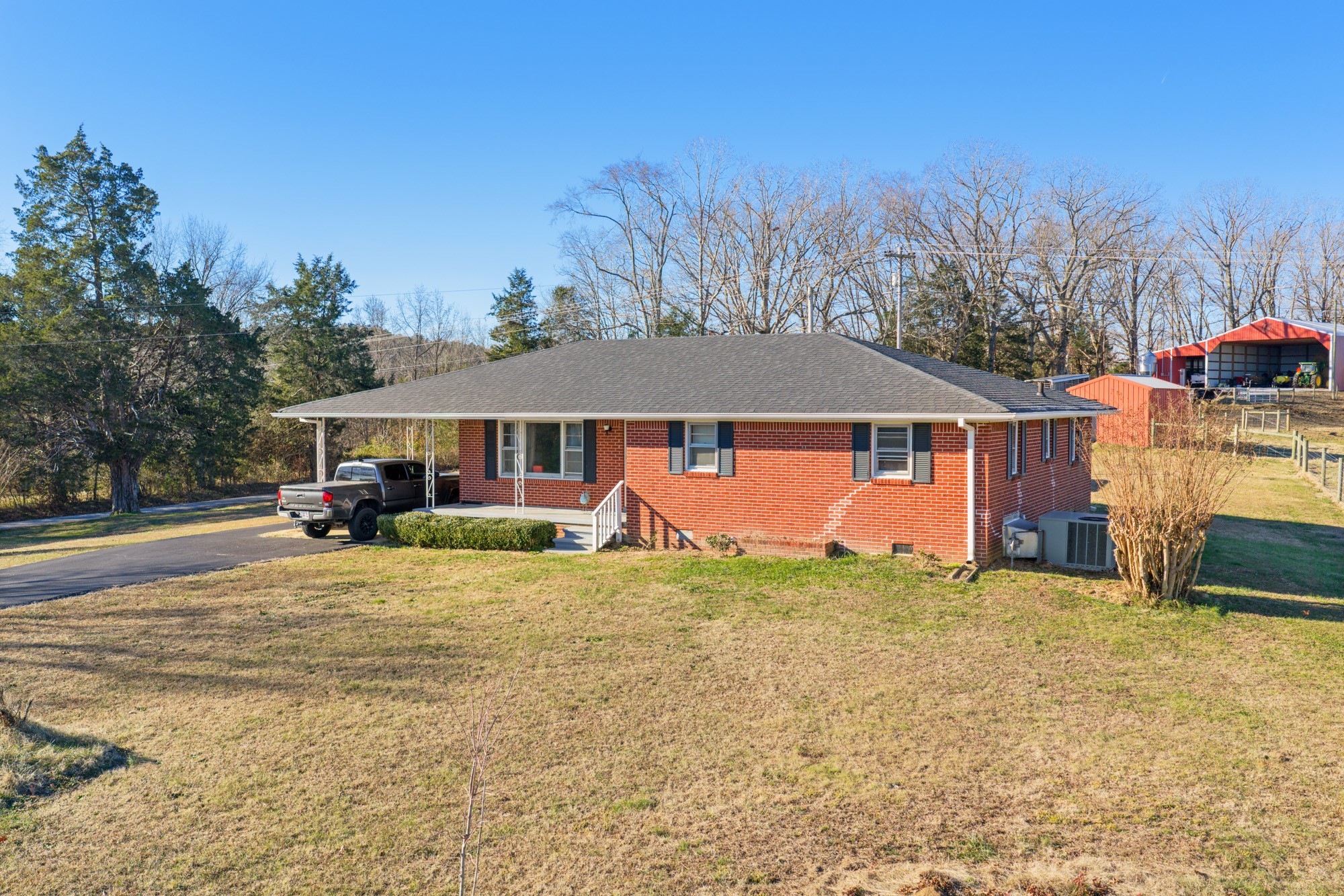 2095 Bible Hill Road Parsons, TN 38363 - Photo 3 of 20 a front view of a house with a yard and garage