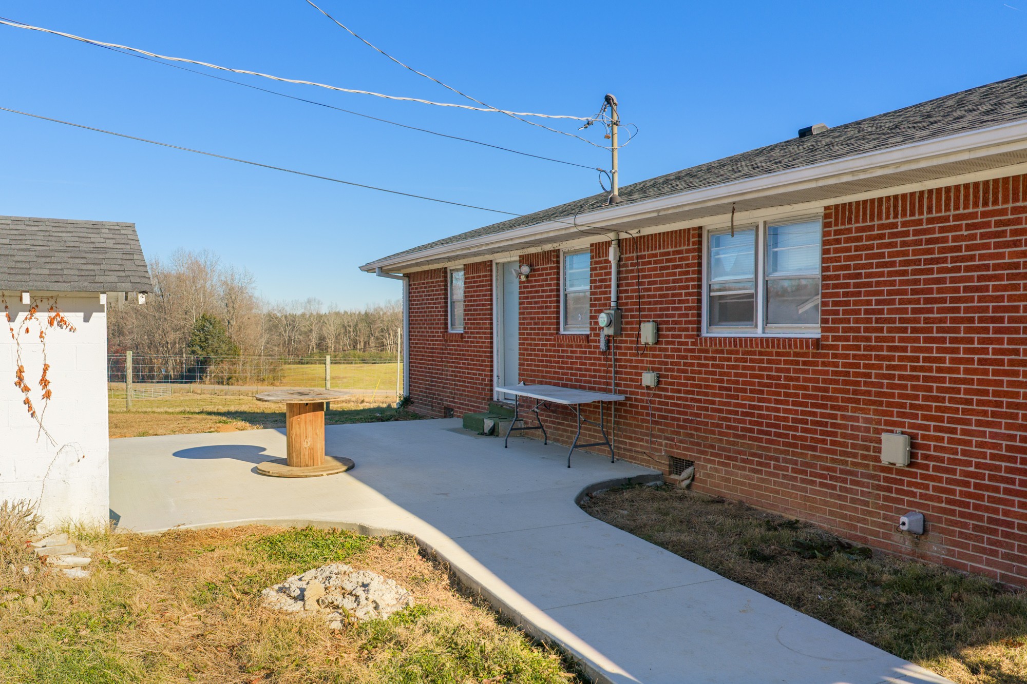2095 Bible Hill Road Parsons, TN 38363 - Photo 9 of 20 a view of a house with backyard and sitting area