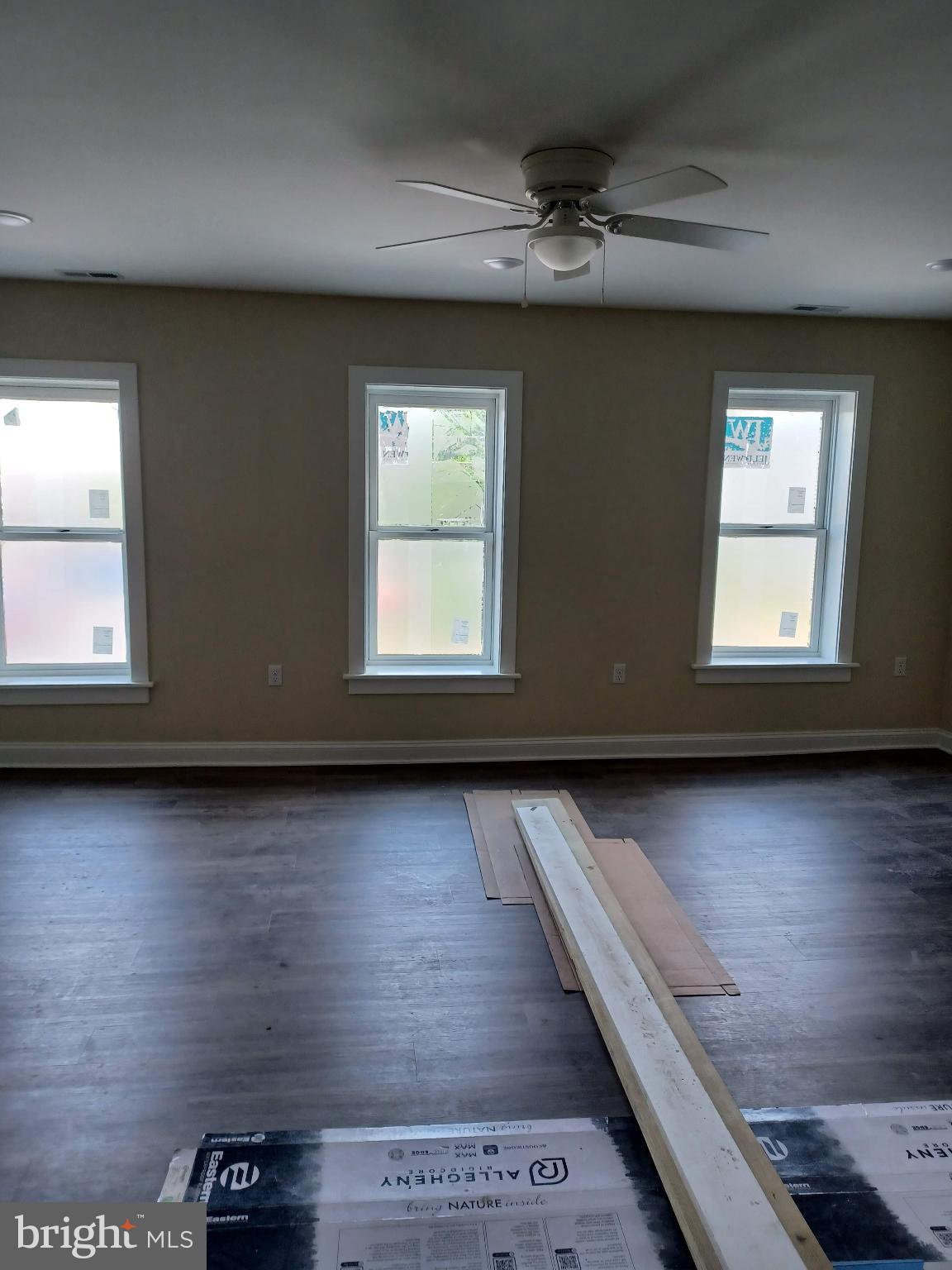 a view of wooden floor and windows in a room