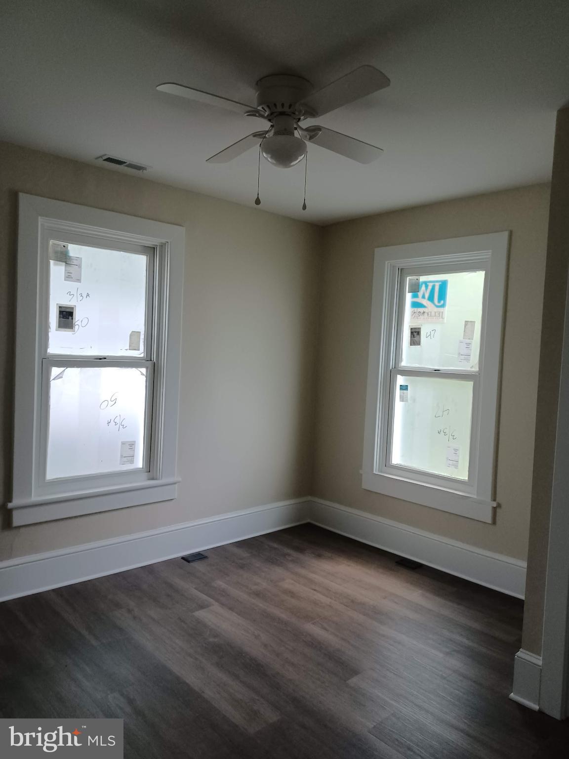 302 North Kent Street Winchester, VA 22601 - Photo 4 of 11 an empty room with wooden floor and windows