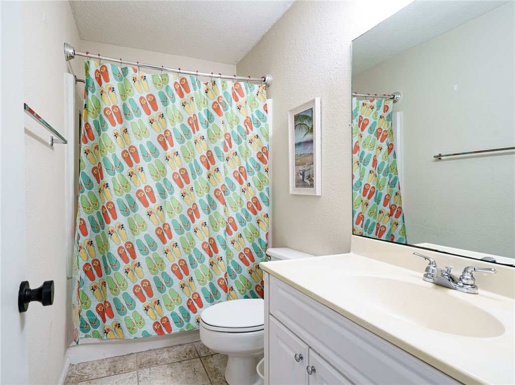 2328 Sadler Road, Unit 1E Fernandina Beach, FL 32034 - Photo 11 of 31 a bathroom with a sink toilet and shower curtain