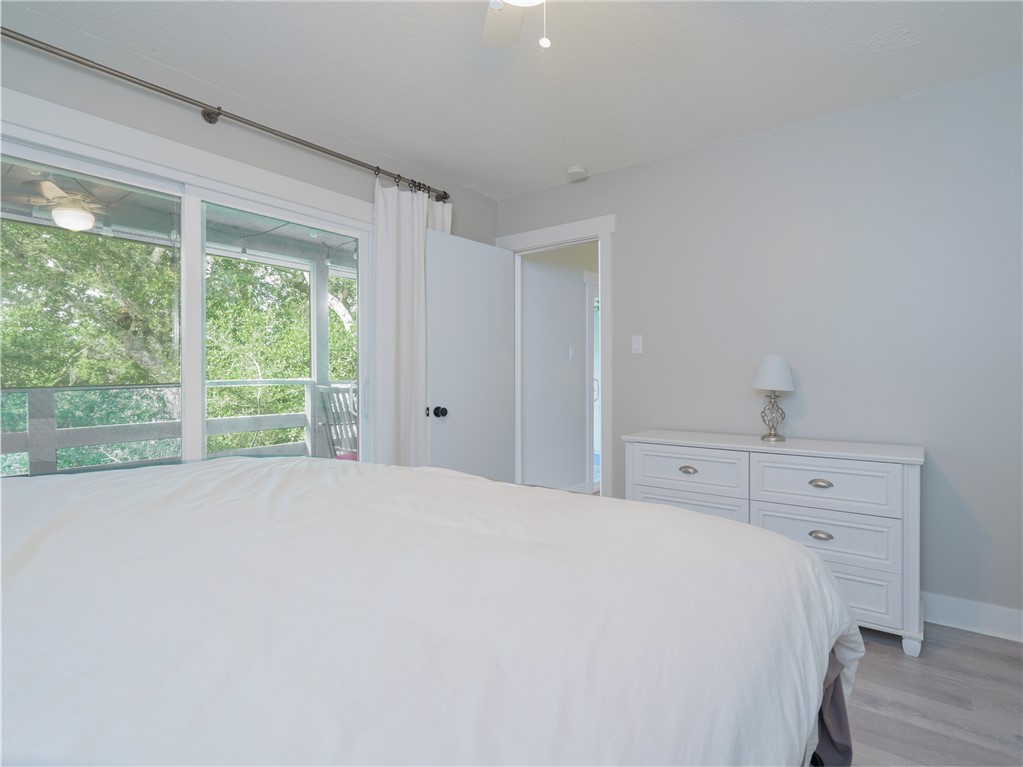 2328 Sadler Road, Unit 1E Fernandina Beach, FL 32034 - Photo 14 of 31 a large white bed in a bedroom next to a window