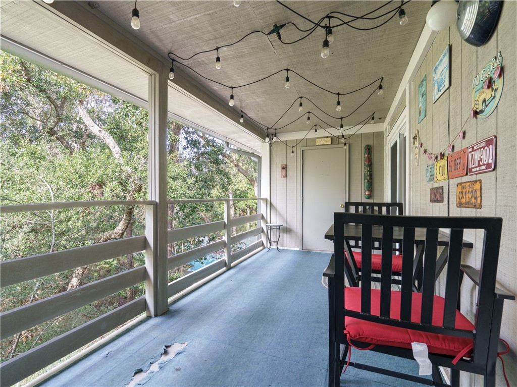 2328 Sadler Road, Unit 1E Fernandina Beach, FL 32034 - Photo 18 of 31 a view of a porch with furniture and a floor to ceiling window