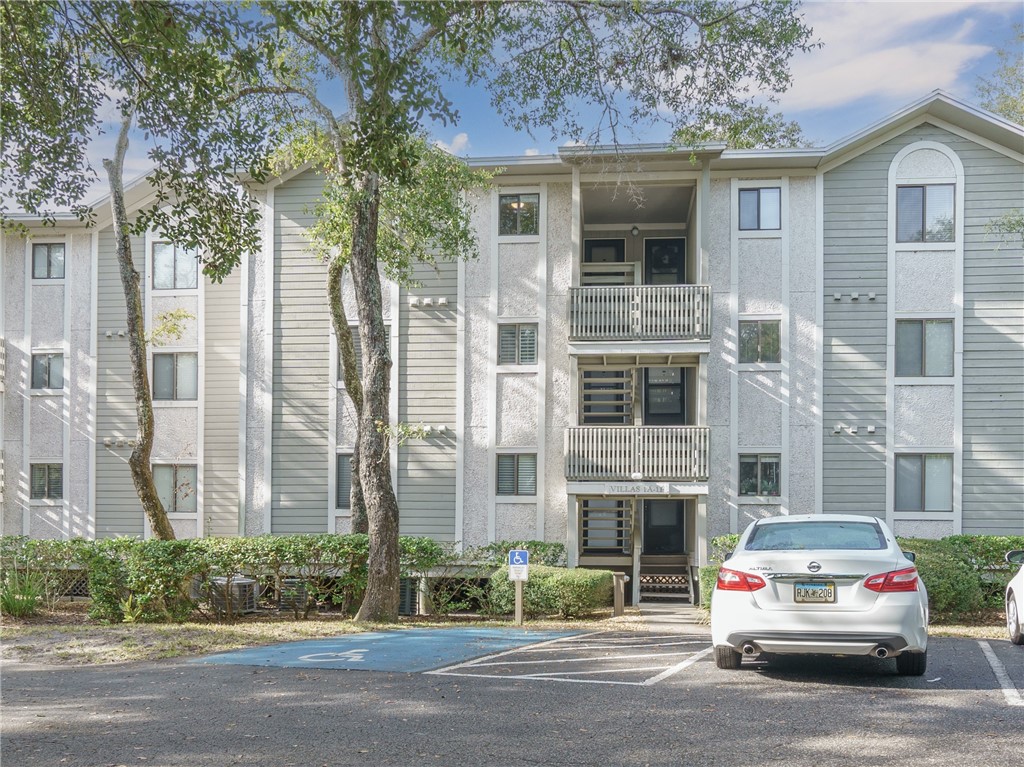 2328 Sadler Road, Unit 1E Fernandina Beach, FL 32034 - Photo 2 of 31 a car parked in front of a building
