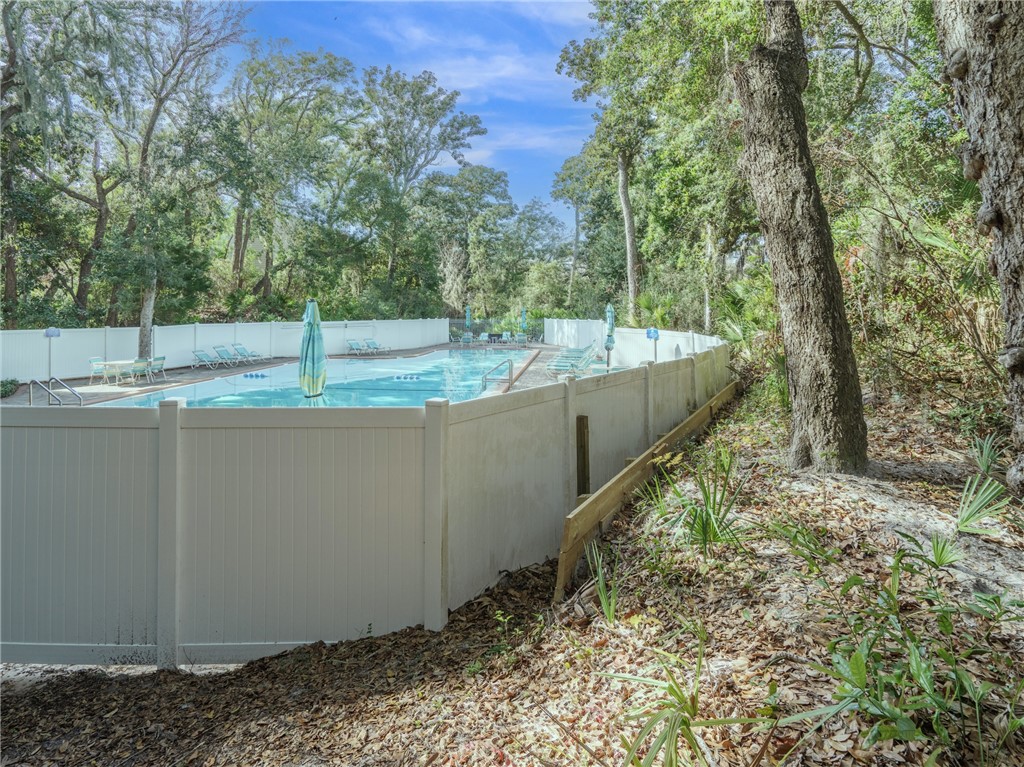 2328 Sadler Road, Unit 1E Fernandina Beach, FL 32034 - Photo 27 of 31 a view of a backyard with trees