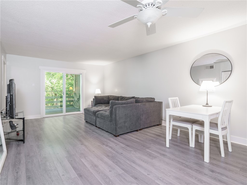 2328 Sadler Road, Unit 1E Fernandina Beach, FL 32034 - Photo 5 of 31 a living room with furniture wooden floor and a large window